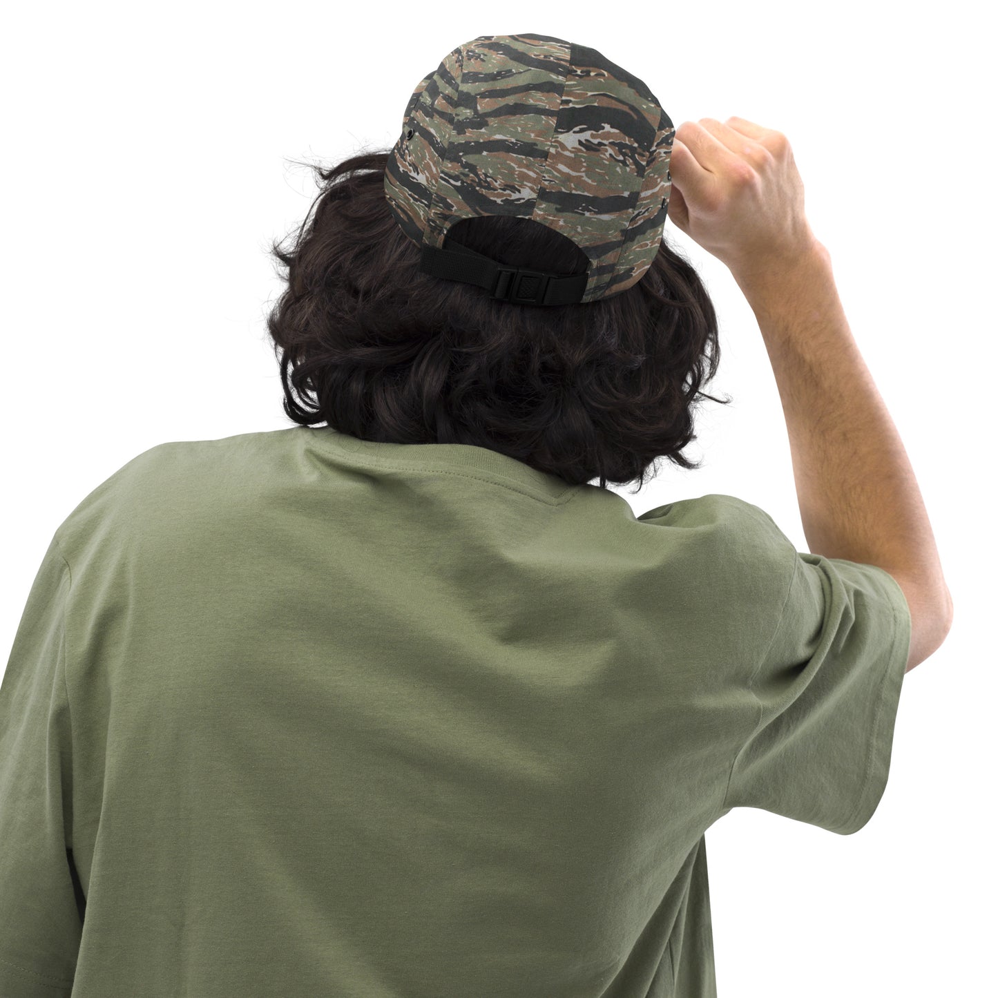 Chillhawk Five Panel Cap green tiger camo - back view of a person with medium-toned skin and dark, wavy hair, wearing the green tiger camo cap and an olive green t-shirt, adjusting the strap on the back of the cap with their right hand.
